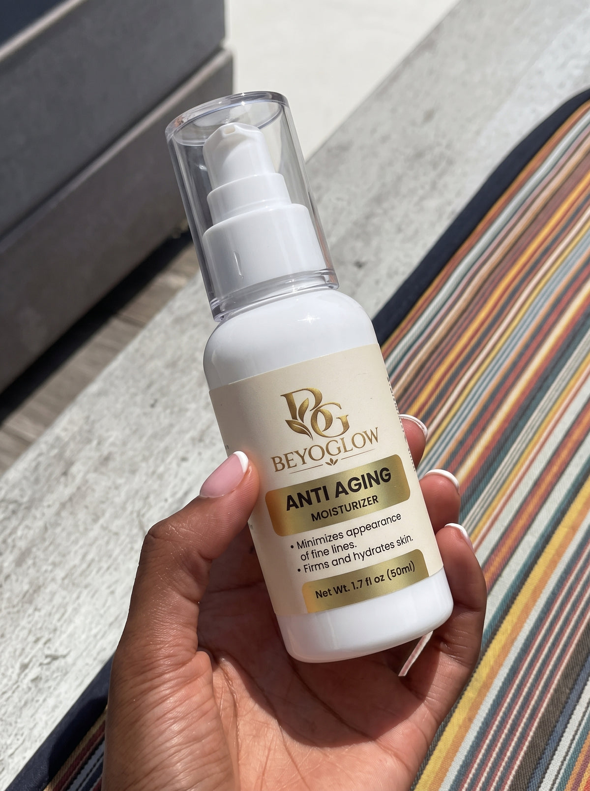 Taking a small amount of BEYOGLOW Anti Aging Moisturizer from the jar